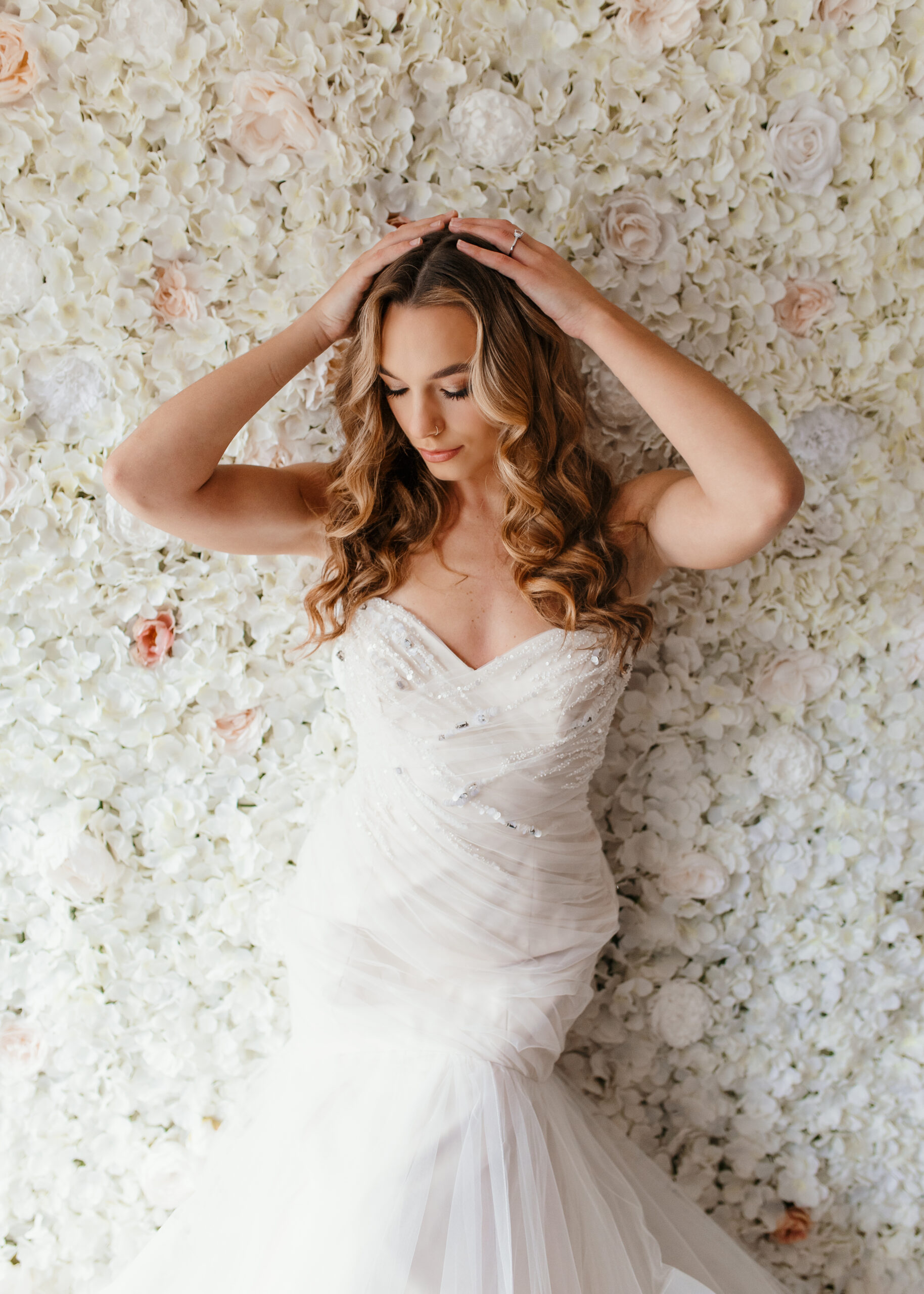 Bridal boudoir client leaning on rose posing for boudoir photo shoot in Richmond Virginia