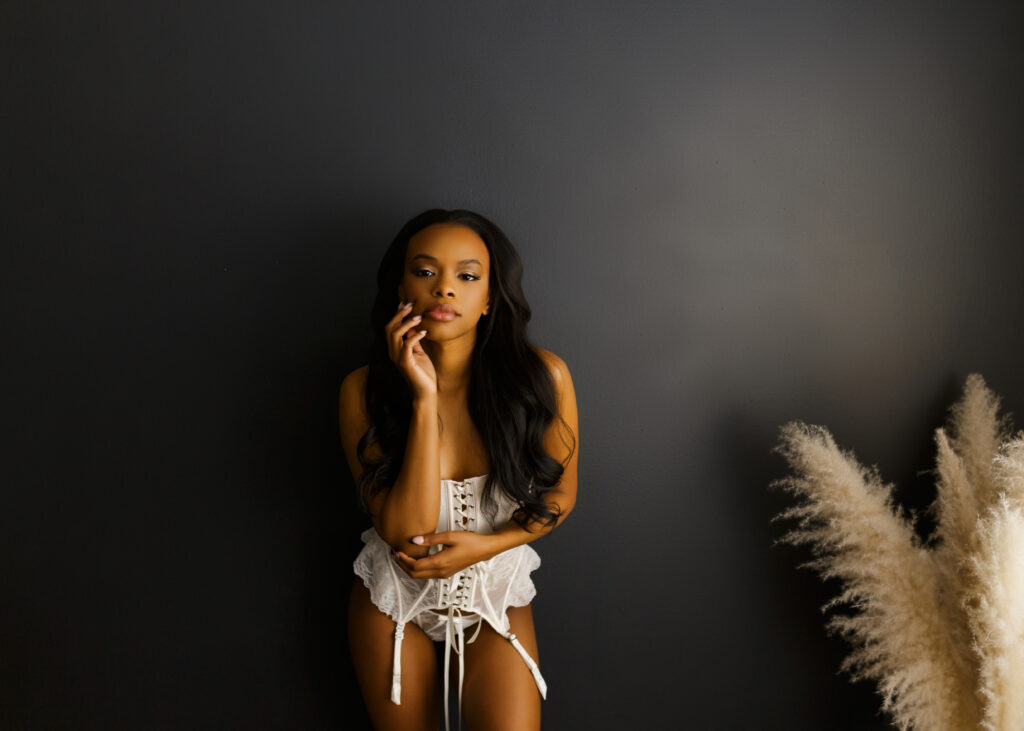 Beautiful black woman in lingerie posing on wall during a boudoir photoshoot in Richmond Virginia 