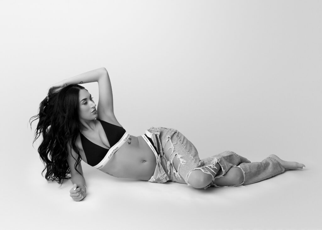 model laying on ground at studio modeling calvin Klein underwear at a boudoir photo shoot in Richmond VA.